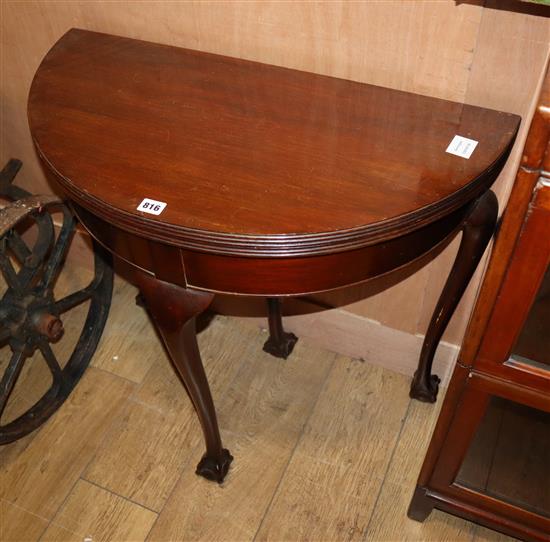 A mahogany Georgian style demi lune card table with ball and claw feet W.76cm